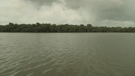 calm river waters around the goa area in india, foggy cloudy weather