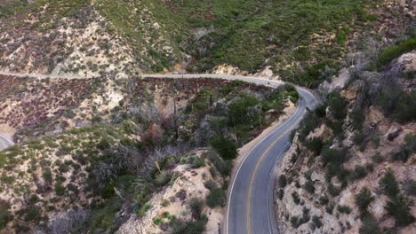 a bird's eye view of motorcycles on a joyride along a mountainous road