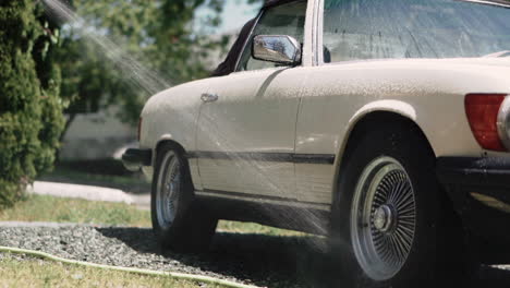 spraying the car with water on a sunny summer day in canada