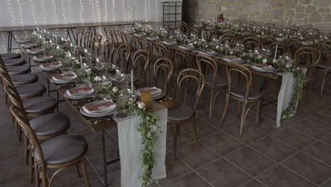 elegant event or wedding reception setup with long tables and floral decor