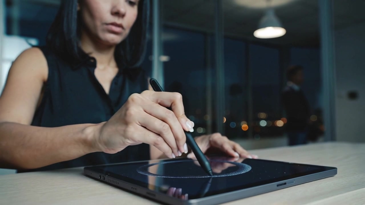 Stylus touching tablet at office, designer in black blouse tracing circular ring refining design