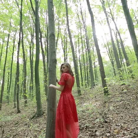 beautiful woman walking through green forest