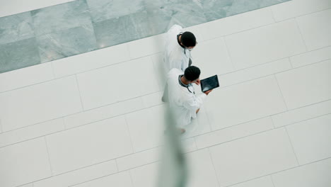 doctors discussing on a tablet in a hospital