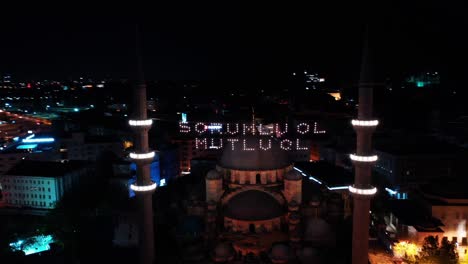 aerial night view of new mosque. there says " be responsible, be happy"