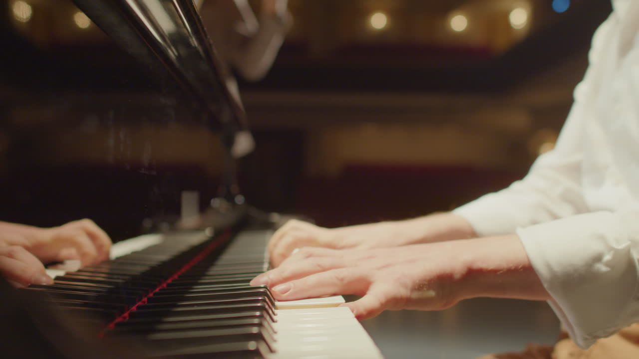 Musician Playing Piano Accompanied by Violin on Stage