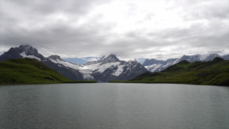 Timelapse-Schreckhorn-and-Wetterhorn-from-Bachalpsee-lake-with-cloudy,-Bernese-Oberland,-Switzerland,-Europe