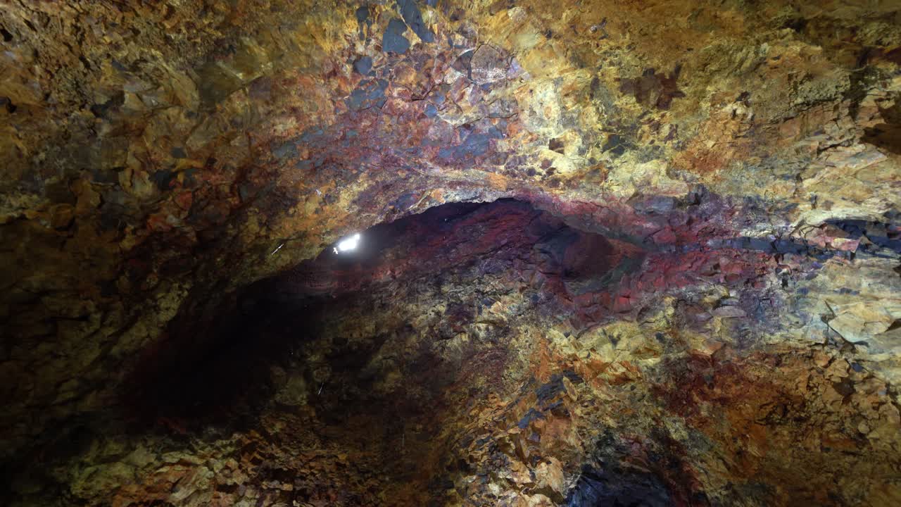 View from the inside of a volcano in Iceland with colorful rock formations.