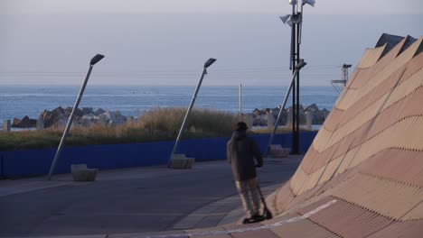 vista trasera del hombre en scooter eléctrico en parc del forum