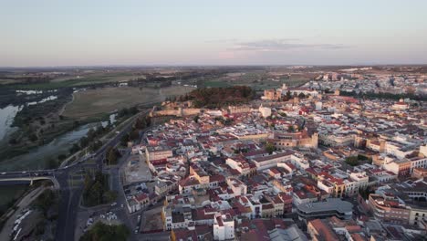 Aerial-flyover-of-Spanish-border-town-Badajoz,-scenic-view-of-Guadiana-river