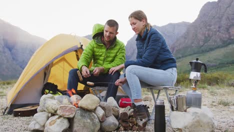 caucasian couple eating in nature