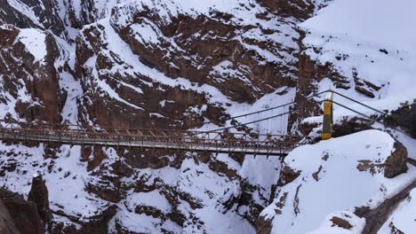 snowy mountain suspension bridge