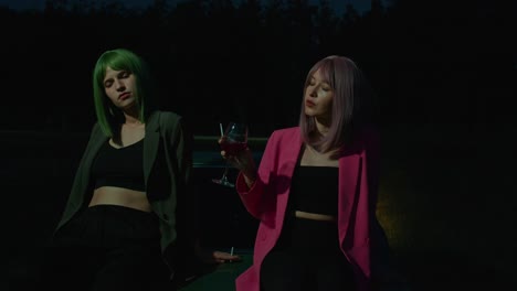 two women in fashionable outfits enjoying a night out