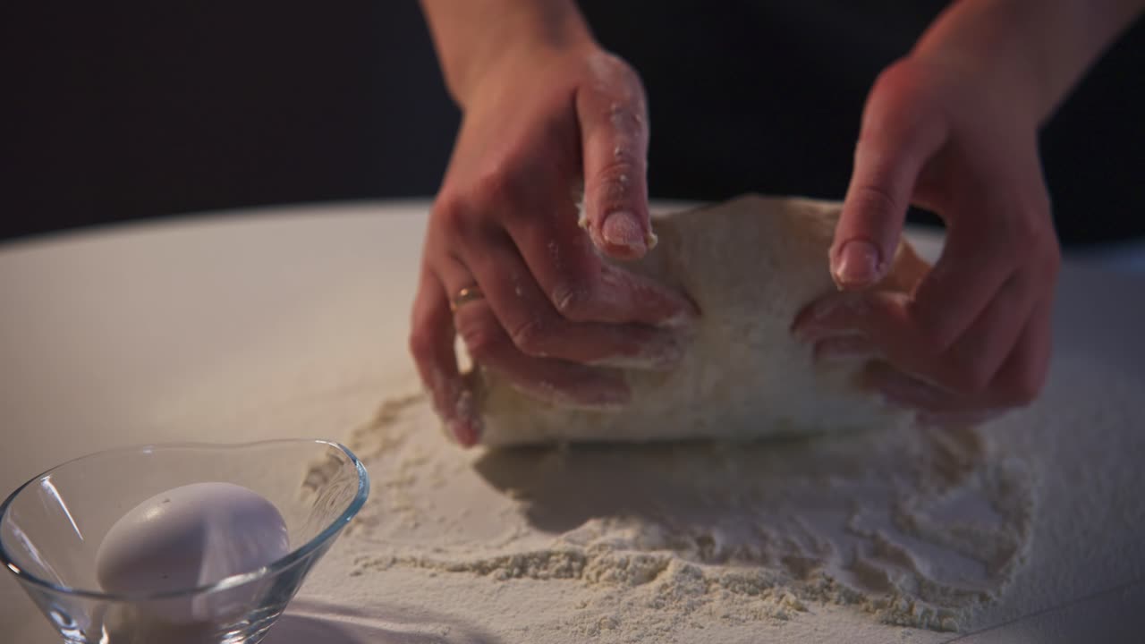 Close-Up of Hands Kneading Fresh Dough on a Floured Surface