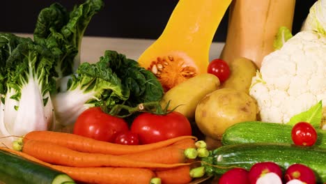 assorted vegetables displayed against a dark backdrop