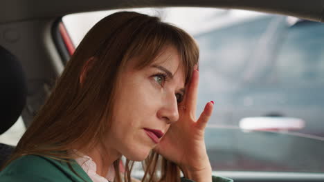 annoyed businesswoman driver stands in traffic jam in city