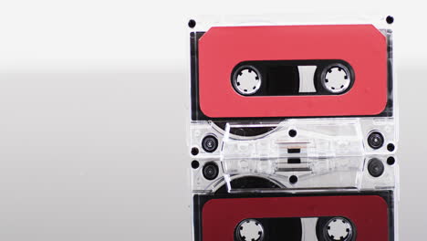 video of retro cassette tape with red label and reflection with copy space on white background