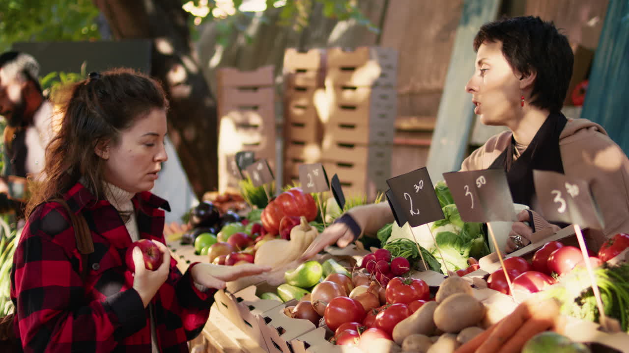 Women shopping at a fruit and vegetable stand
