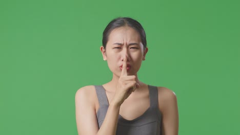 woman with finger on lips