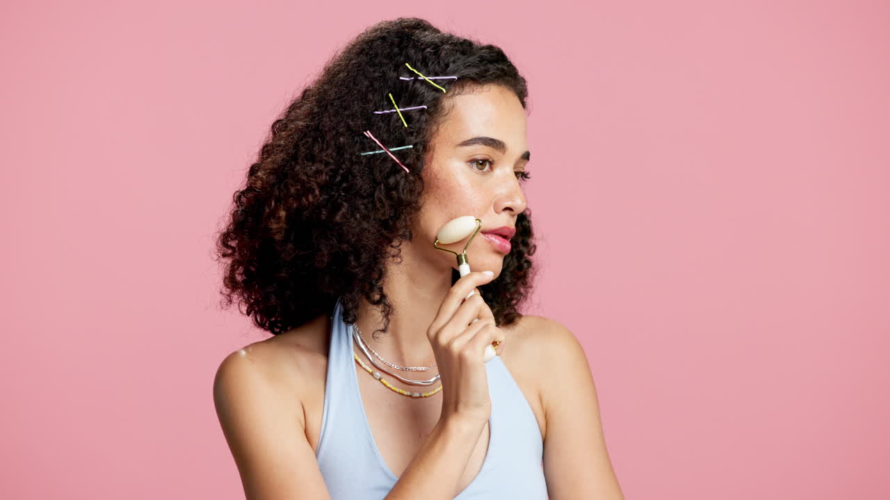 Woman using jade roller for skincare