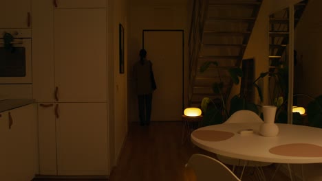 woman walking through a home at night