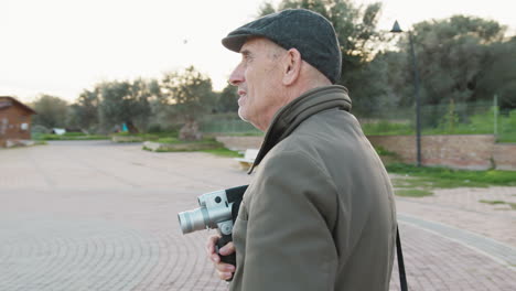 expert videomaker seeks inspiration holding a vintage camera
