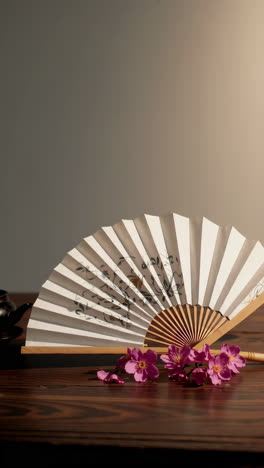 elegant asian still life with fan and flowers