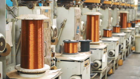 copper wire winding on coils at factory. bronze cable rolling on reels at plant