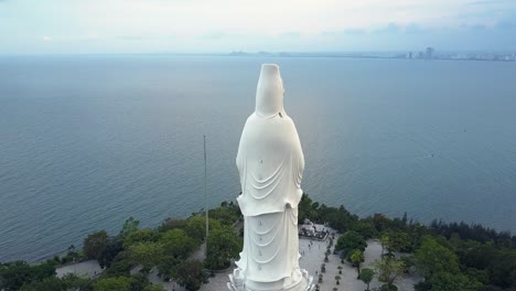 upper round motion huge white buddha statue on ocean coast