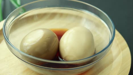 soy sauce marinated eggs in a glass bowl