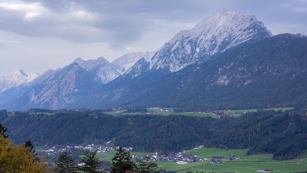 A stunning timelapse of the Alps in Schwaz, Austria, captured in the early morning with clouds gracefully moving across the majestic mountain landscape.