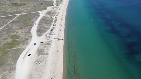 Epanomi-Shipwreck-and-Beach:-A-Greek-Summer-Day-Awash-with-Sun,-Waves,-and-4K-Aerial-Beauty