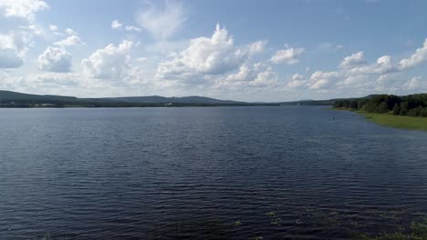 Drone-shot-of-a-big-lake-under-the-summersky