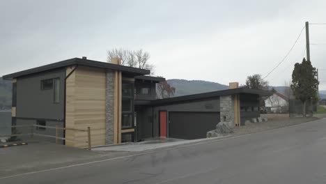 a newly built house overlooking a lake