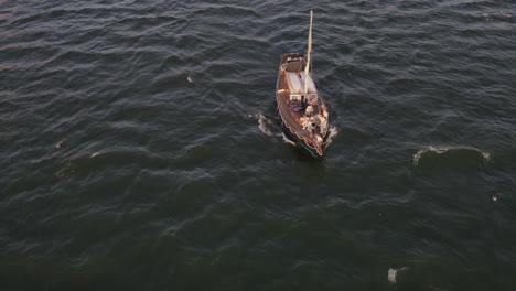 Aerial:-Rabelo-Tourist-Boat-sailing-Douro-River-in-Porto,-Portugal