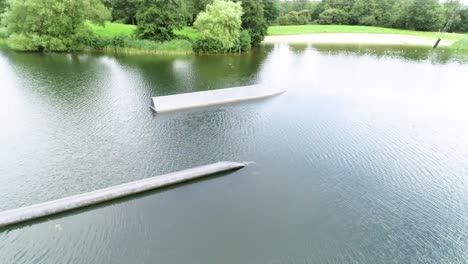 drone shot of jumps and obstacles at a water sport park for waterskiing and wakeboarding