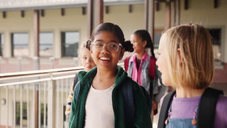group of students walking in school corridor