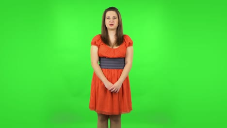 woman in orange dress with a surprised expression