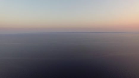 aerial waterscape with vast sea at sunset