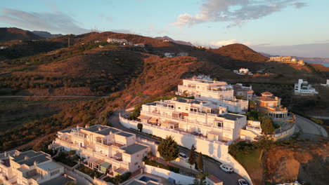 tiro ascendente mirando casas lujosas en españa y revelando hermosas montañas en el fondo