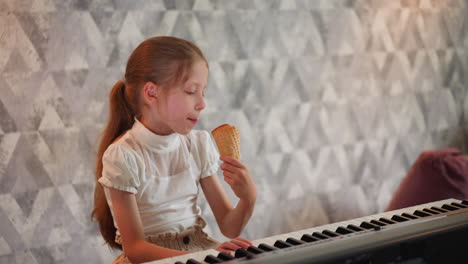 kid with hand on piano enjoying ice cream cone while eating crispy cone, sitting in front of keyboard, against artistic patterned wall background
