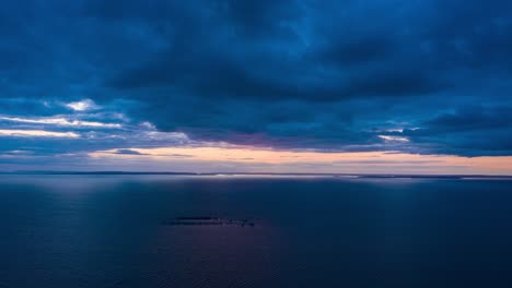 sunset over a fish farm on a calm lake