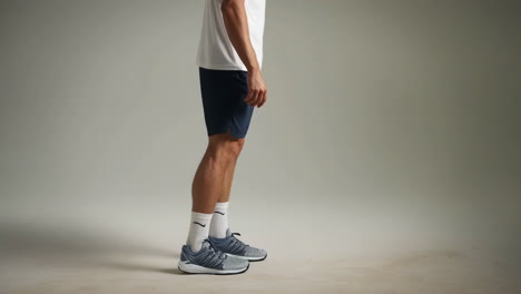 man tying shoelace while preparing for exercise