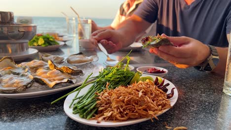 enjoying oysters and seafood by the sea