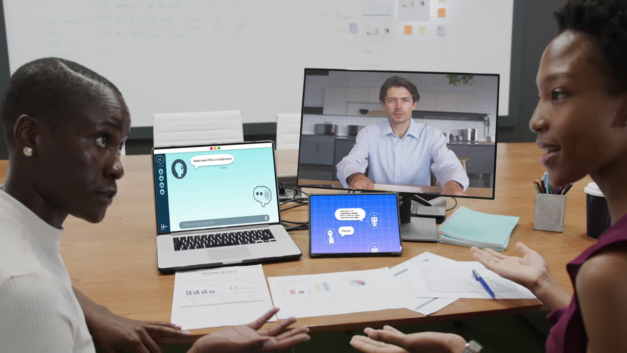Diverse business people having video call and using laptop with digital chat on screen in office