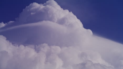 cumulus clouds against a deep blue sky