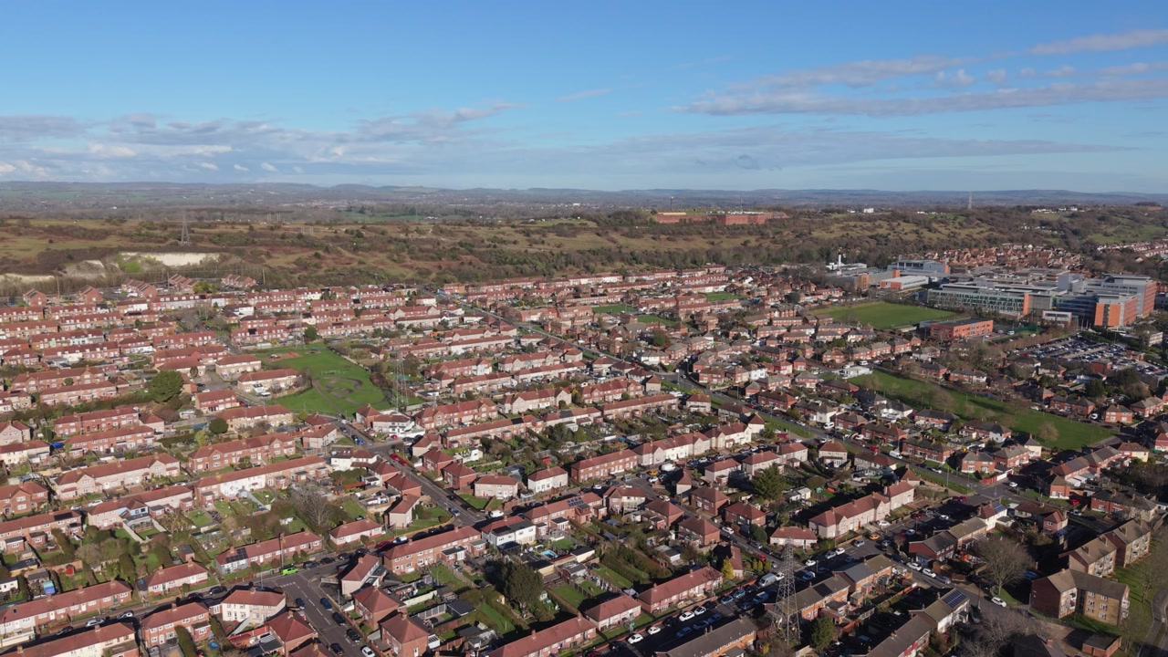 Swanick Hill Portsmouth distant high reveal drone flight over housing estates and green spaces Queen Alexandra Hospital and distant countryside views in bright sun