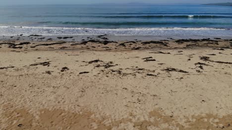 Drone-is-fast-approaching-ocean-from-sandy-dunes