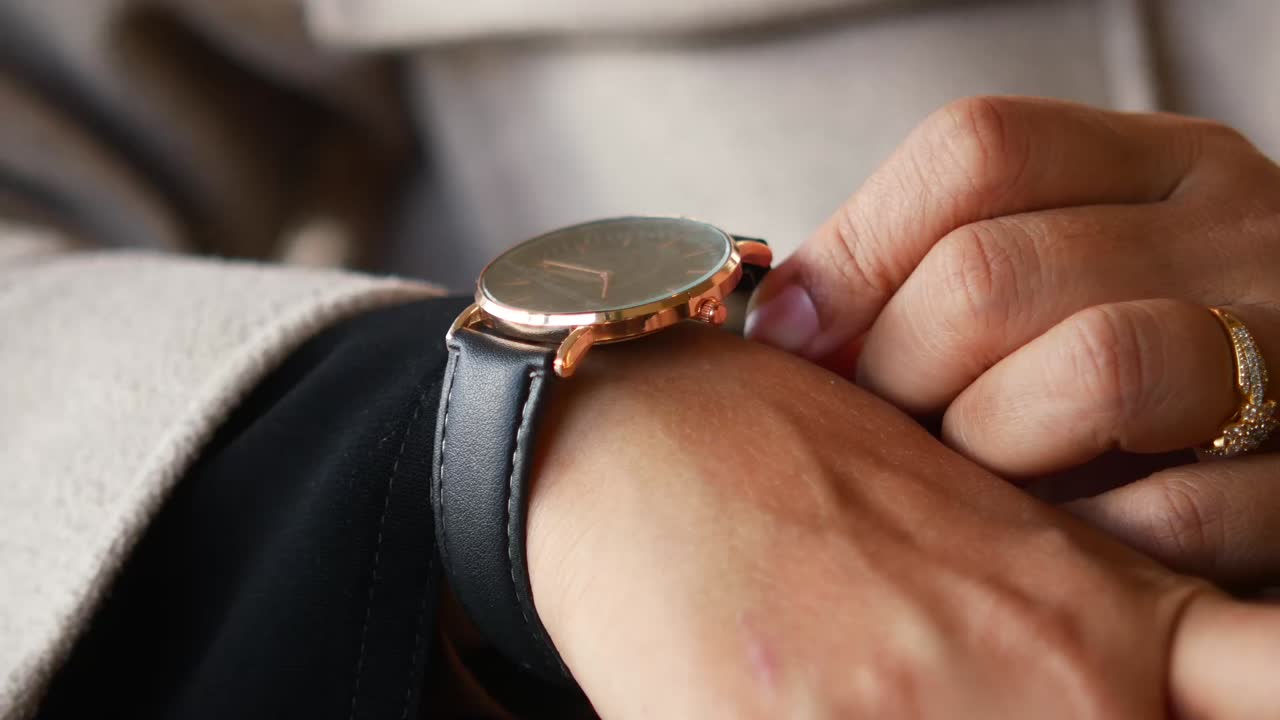Close up of a hand wearing a watch and ring