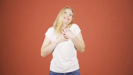 the woman who happily puts the phone to her heart.