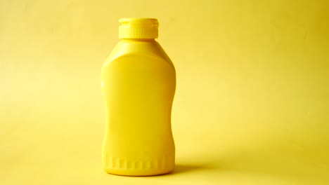 mustard mayonnaise in yellow container on yellow background ,